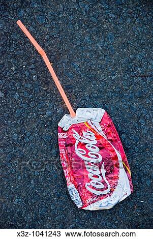 A crushed Coca Cola can with straw View Large Photo Image Stock Image - A crushed Coca Cola can with straw. Fotosearch