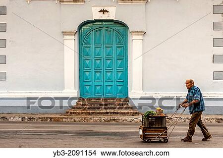 A Cuban Man Pushes A Trolley of Fruit To Market, Sancti Spiritus, Cuba. View Large Photo Image Picture - A Cuban Man Pushes A Trolley of Fruit To Market, Sancti Spiritus, Cuba.. Fotosearch