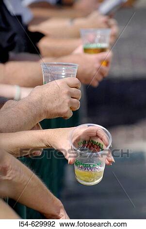 A cup of beer in hands of spectator at a sporting event View Large Photo Image Stock Image - A cup of beer in hands of spectator at a sporting event. Fotosearch