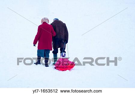A cute old couple pull their granddaughter along the snow in Cambridge, England View Large Photo Image Stock Image - A cute old couple pull their granddaughter along the snow in Cambridge, England. Fotosearch