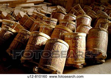 A cylinder containing or inscribed with prayers or litanies that is revolved on its axis in devotions, especially by Tibetan Buddhists View Large Photo Image Stock Image - A cylinder containing or inscribed with prayers or litanies that is revolved on its axis in devotions, especially by Tibetan Buddhists. Fotosearch