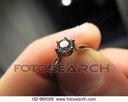 A diamond ring in the finger View Large Photo Image Stock Photograph - A diamond ring in the finger. Fotosearch