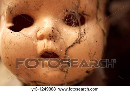Stock Photo - A doll covered with spider web hangs on a tree on the Island of the Dolls in Xochimilco, southern Mexico City.. Fotosearch