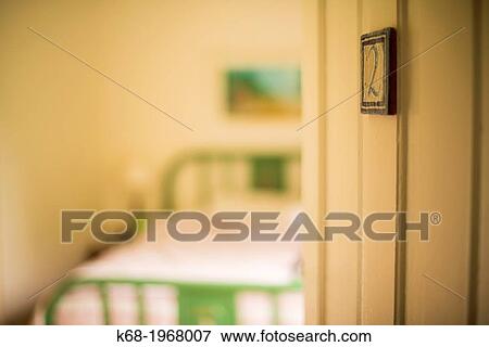 A door opens to a bedroom in an historic hotel View Large Photo Image Stock Photo - A door opens to a bedroom in an historic hotel. Fotosearch