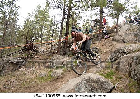Stock Photography - A downhill mountain biker in a race. Fotosearch