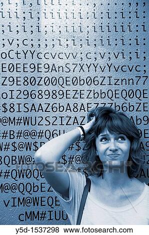 A face of young woman in front of numbers, letters, symbols, background is a painted wall of one of the buildings in Geneva, Switzerland View Large Photo Image Stock Photo - A face of young woman in front of numbers, letters, symbols, background is a painted wall of one of the buildings in Geneva, Switzerland. Fotosearch