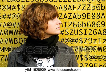 A face of young woman in front of numbers, letters, symbols, background is a painted wall of one of buildings in Geneva, Switzerland View Large Photo Image Stock Photo - A face of young woman in front of numbers, letters, symbols, background is a painted wall of one of buildings in Geneva, Switzerland. Fotosearch
