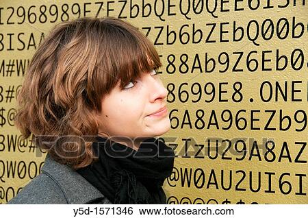 A face of young woman in front of numbers, letters, symbols, background is a painted wall of one of buildings in Geneva, Switzerland View Large Photo Image Stock Photograph - A face of young woman in front of numbers, letters, symbols, background is a painted wall of one of buildings in Geneva, Switzerland. Fotosearch