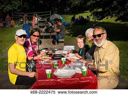 A family at a picnic table View Large Photo Image Stock Photography - A family at a picnic table. Fotosearch