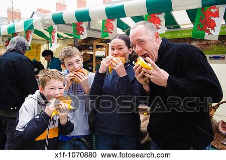 A family eating freshly cooked organic wild boar burgers, Aberystwyth Farners Market, Wales UK View Large Photo Image Stock Image - A family eating freshly cooked organic wild boar burgers, Aberystwyth Farners Market, Wales UK. Fotosearch