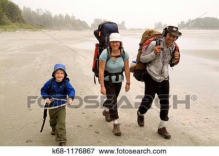 A family of three hike together on the beach on Flores Island, Clayoquot Sound, BC, Canada View Large Photo Image Stock Photo - A family of three hike together on the beach on Flores Island, Clayoquot Sound, BC, Canada. Fotosearch