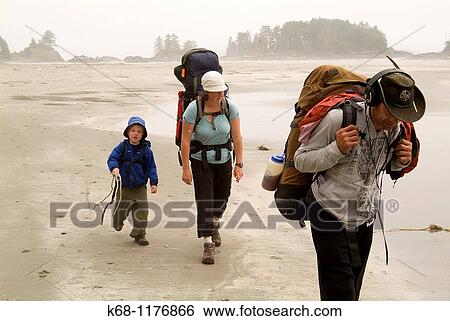 A family of three hike together on the beach on Flores Island, Clayoquot Sound, BC, Canada View Large Photo Image Stock Photograph - A family of three hike together on the beach on Flores Island, Clayoquot Sound, BC, Canada. Fotosearch