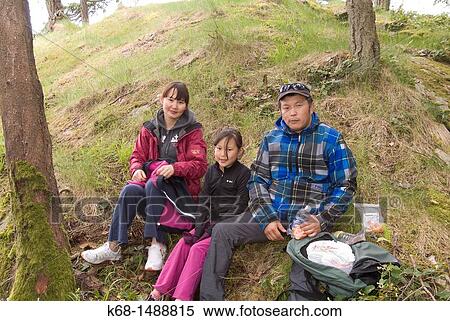 a family of three sits on a hillside on Saltspring Island, Gulf Islands, BC, Canada View Large Photo Image Stock Photography - a family of three sits on a hillside on Saltspring Island, Gulf Islands, BC, Canada. Fotosearch