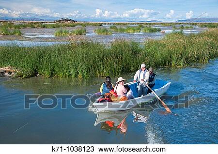 A family on a boat near the floating Islands in Lake Titicaca, Peru, South America View Large Photo Image Stock Image - A family on a boat near the floating Islands in Lake Titicaca, Peru, South America. Fotosearch
