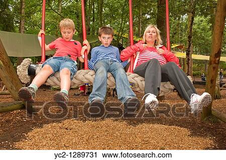 A family on a swing showing movement at Bewilderwood adventure park in Hoveton, Norfolk, England, Great Britain, Uk View Large Photo Image Stock Image - A family on a swing showing movement at Bewilderwood adventure park in Hoveton, Norfolk, England, Great Britain, Uk. Fotosearch
