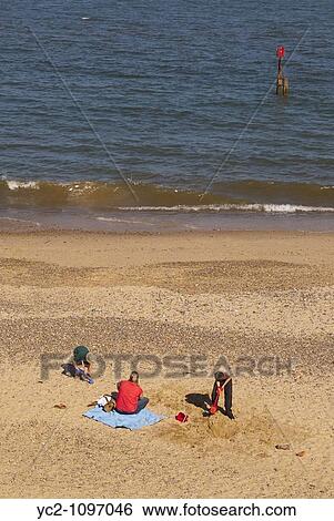 A family on a Uk beach View Large Photo Image Stock Photograph - A family on a Uk beach. Fotosearch