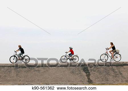 A family riding bicycle View Large Photo Image Stock Image - A family riding bicycle. Fotosearch