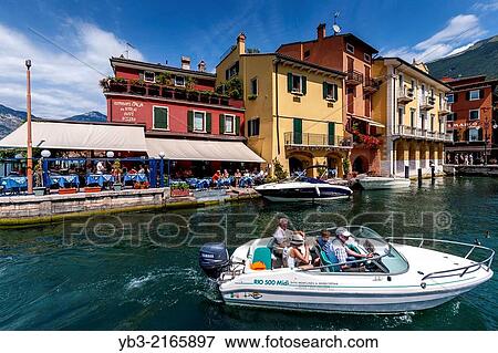 A Family Taking A Speedboat Trip, Malcesine, Lake Garda, Italy. View Large Photo Image Stock Photo - A Family Taking A Speedboat Trip, Malcesine, Lake Garda, Italy.. Fotosearch