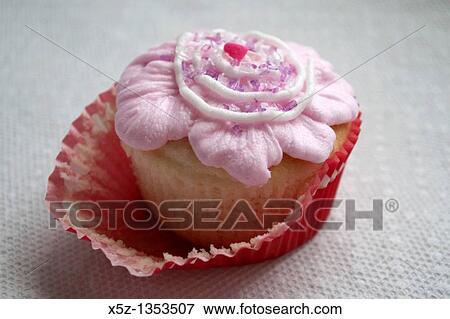 A fancy frosted cupcake half unwrapped View Large Photo Image Stock Photo - A fancy frosted cupcake half unwrapped. Fotosearch