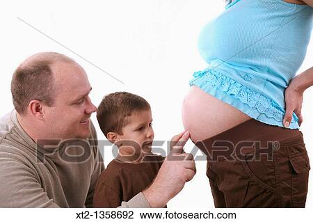 A father and his son touch his mothers pregnant stomache, isolated on white background View Large Photo Image Stock Image - A father and his son touch his mothers pregnant stomache, isolated on white background. Fotosearch