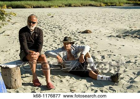 A father and son sit at their campsite on Flores Island, Clayoquot Sound, British Columbia, Canada View Large Photo Image Stock Photo - A father and son sit at their campsite on Flores Island, Clayoquot Sound, British Columbia, Canada. Fotosearch