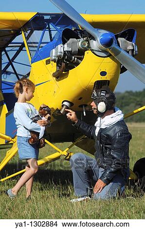 A father private pilot with his young daughter learning a flying lesson around a famous Piper J-3 Cub View Large Photo Image Picture - A father private pilot with his young daughter learning a flying lesson around a famous Piper J-3 Cub. Fotosearch