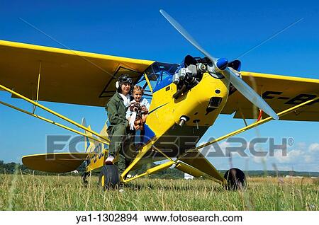 A father private pilot with his young daughter in the famous Piper J-3 Cub View Large Photo Image Picture - A father private pilot with his young daughter in the famous Piper J-3 Cub. Fotosearch
