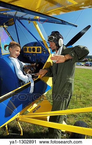 A father private pilot with his young daughter learning a flying lesson in cockpit of the famous Piper J-3 Cub View Large Photo Image Stock Image - A father private pilot with his young daughter learning a flying lesson in cockpit of the famous Piper J-3 Cub. Fotosearch