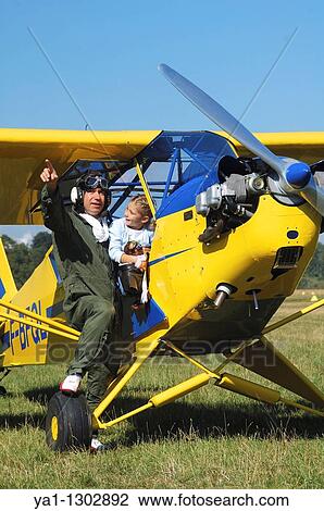 Stock Image - A father private pilot with his young daughter in the famous Piper J-3 Cub. Fotosearch