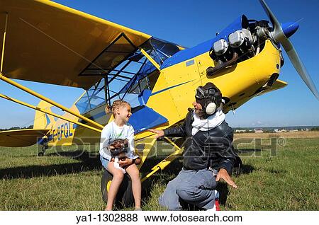 A father private pilot with his young daughter learning a flying lesson around a famous Piper J-3 Cub View Large Photo Image Stock Photo - A father private pilot with his young daughter learning a flying lesson around a famous Piper J-3 Cub. Fotosearch