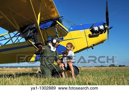 A father private pilot with his young daughter learning a flying lesson around a famous Piper J-3 Cub View Large Photo Image Stock Photo - A father private pilot with his young daughter learning a flying lesson around a famous Piper J-3 Cub. Fotosearch