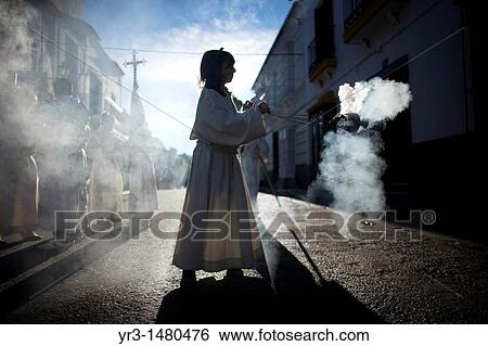 A female acolyte spreads incense during an Easter Holy Week procession in Prado del Rey, Andalusia, Spain, April 24, 2011 View Large Photo Image Stock Photograph - A female acolyte spreads incense during an Easter Holy Week procession in Prado del Rey, Andalusia, Spain, April 24, 2011. Fotosearch