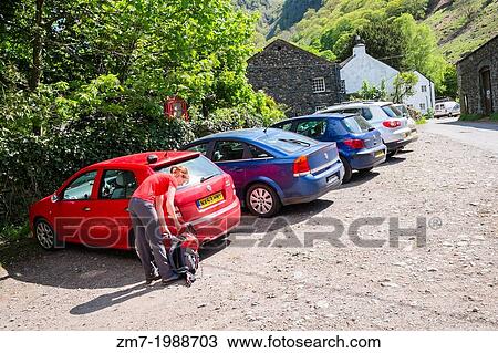 A female hiker returning to a parked car at Stonethwaite in the Lake District. View Large Photo Image Stock Image - A female hiker returning to a parked car at Stonethwaite in the Lake District.. Fotosearch