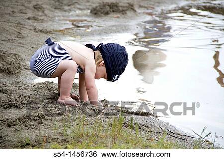 A female toddler at Fish Lake, playing in the sand. Spokane, Washington, USA View Large Photo Image Stock Photograph - A female toddler at Fish Lake, playing in the sand. Spokane, Washington, USA. Fotosearch