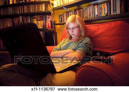 A fifteen year old teenage girl viewing her Facebook page on her laptop computer at home UK View Large Photo Image Stock Photo - A fifteen year old teenage girl viewing her Facebook page on her laptop computer at home UK. Fotosearch