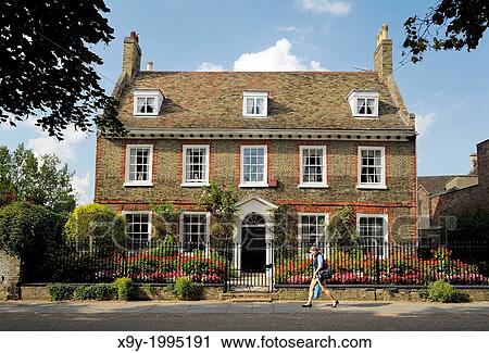 Stock Image - A fine English brick town house on Palace Green close to West Door of Ely Cathedral. Cambridgeshire, England.. Fotosearch