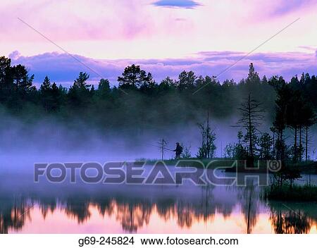 A fisherman on a misty lake in Byske. Vasterbotten. Sweden View Large Photo Image Picture - A fisherman on a misty lake in Byske. Vasterbotten. Sweden. Fotosearch