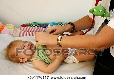 Stock Photo - A five month old baby girl during routine visit at the doctor. Fotosearch