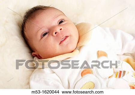A five weeks baby girl looking up View Large Photo Image Picture - A five weeks baby girl looking up. Fotosearch