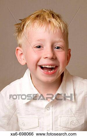 A five-year-old blonde-haired, blue eyed boy is laughing and looking straight at the camera. He is wearing a white shirt and one of his teeth is missing. View Large Photo Image Stock Photograph - A five-year-old blonde-haired, blue eyed boy is laughing and looking straight at the camera. He is wearing a white shirt and one of his teeth is missing.. Fotosearch