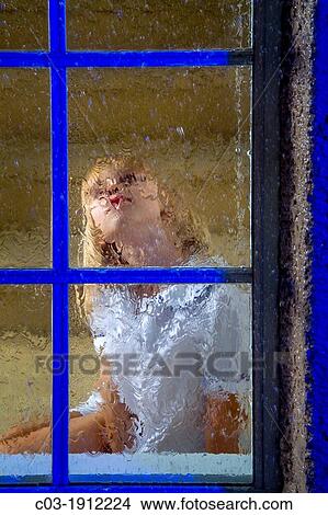 A five-year-old girl looks out her window on a rainy night in suburban Lake Forest, CA View Large Photo Image Picture - A five-year-old girl looks out her window on a rainy night in suburban Lake Forest, CA. Fotosearch