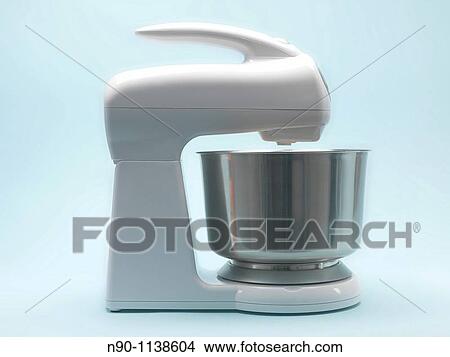 A food mixer isolated against a blue background View Large Photo Image Picture - A food mixer isolated against a blue background. Fotosearch