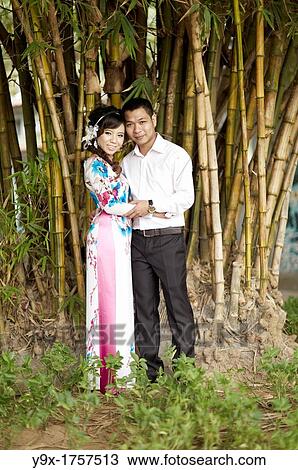 A formally dressed couple having their portrait taken in front of a small bamboo grove View Large Photo Image Stock Image - A formally dressed couple having their portrait taken in front of a small bamboo grove. Fotosearch