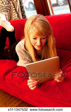 A fourteen year old teenage girl using a digital tablet to read Facebook and email at home, UK View Large Photo Image Stock Image - A fourteen year old teenage girl using a digital tablet to read Facebook and email at home, UK. Fotosearch