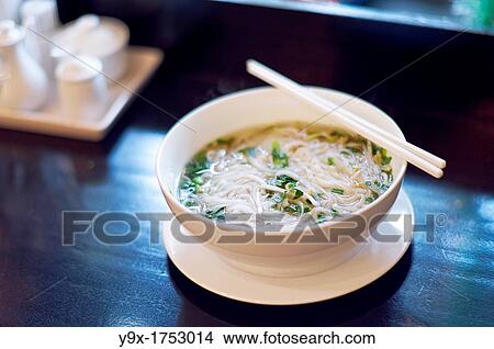 Picture - A fresh warm bowl of Pho, a traditional Vietnamese noodle soup dish. Fotosearch