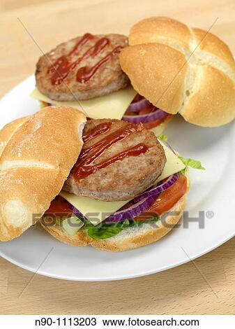 Stock Image - A freshly made American style hamburger with sauce. Fotosearch