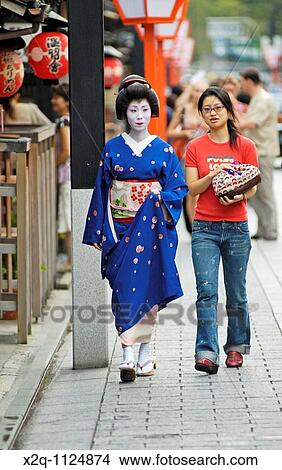 Picture - A geisha geiko and her assistant stroll to an appointment in Gion Kyoto Japan. Fotosearch