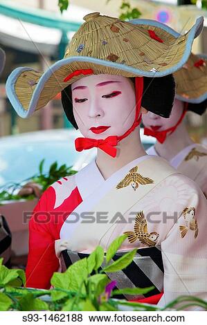 A geisha in a summer kimono wearing a strange hat View Large Photo Image Stock Photo - A geisha in a summer kimono wearing a strange hat. Fotosearch