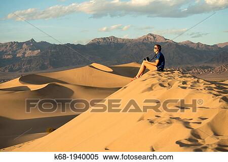 A girl, 17, looks at the sunset from a sand dune in Death Valley National Park, California, USA View Large Photo Image Stock Photography - A girl, 17, looks at the sunset from a sand dune in Death Valley National Park, California, USA. Fotosearch