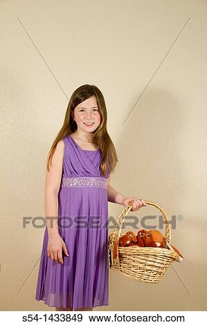 Stock Photo - A girl, 5-10, in a dress indoors. Fotosearch